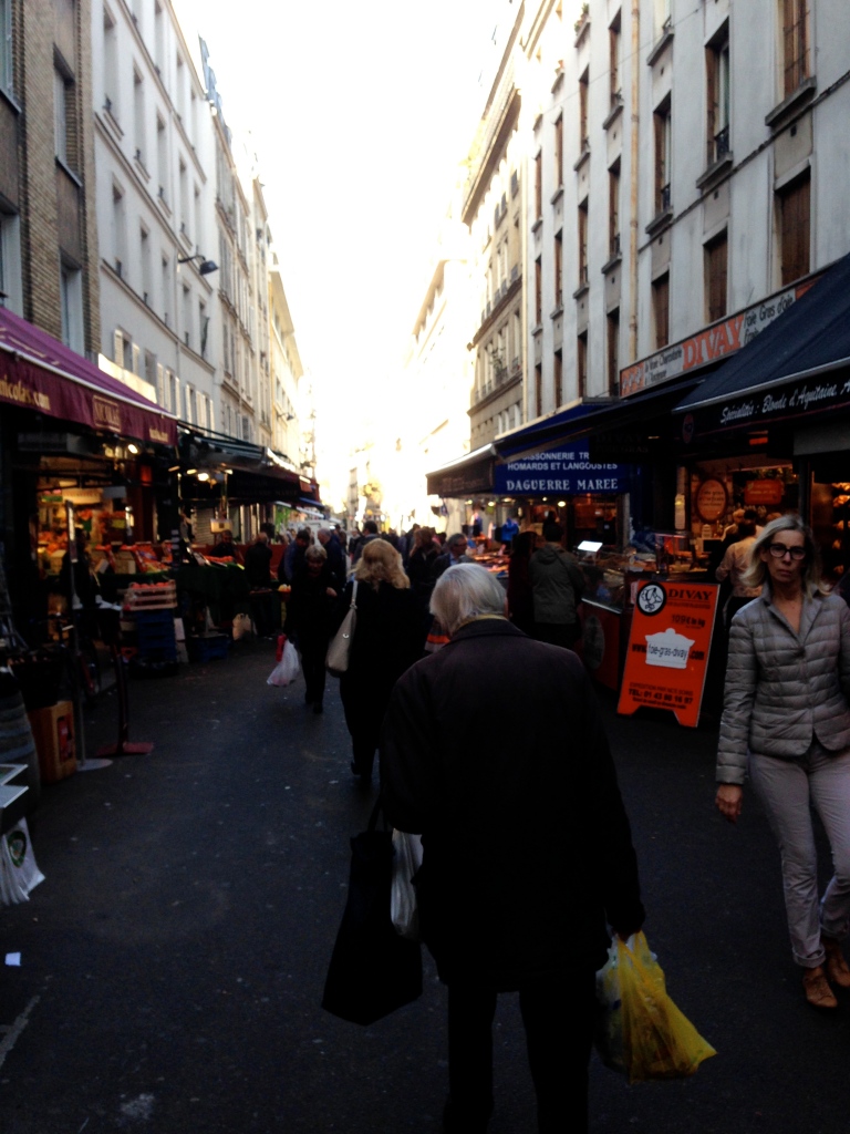 The market on Rue Poncelet on Sunday morning after the attacks. The air might have been more hushed than normal, but families still shopped for vegetables and meat.