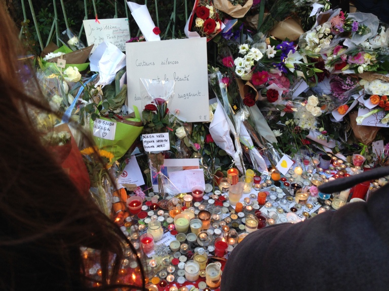 Candles and letters fill the sidewalk on Boulevard Voltaire outside of the Bataclan on Nov. 15, 2015.